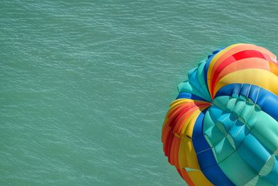 High angle view of hot air balloon flying above sea