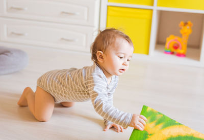 Cute boy playing with toy at home