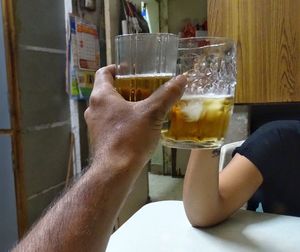 Close-up of man drinking beer glass