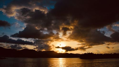 Scenic view of dramatic sky over lake during sunset