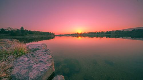 Scenic view of lake against sky during sunset