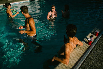 Woman sitting in swimming pool