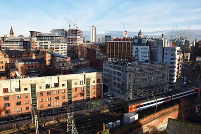 High angle view of buildings in city against sky