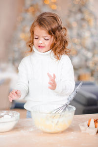 Portrait of girl eating food at home