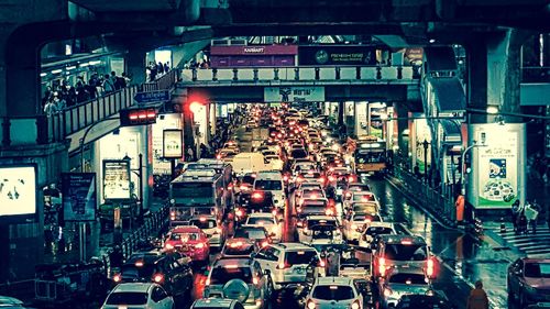 Cars in illuminated city at night