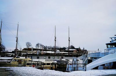 Boats moored at harbor during winter