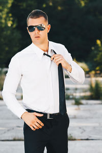 Young man wearing sunglasses standing outdoors
