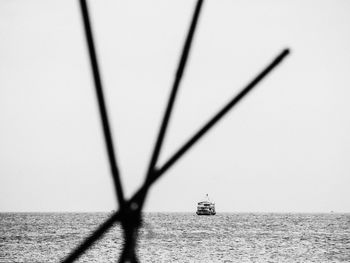 Sailboat sailing on sea against clear sky