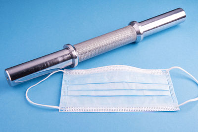 High angle view of pen on table against blue background