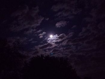 Low angle view of silhouette moon against sky at night