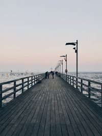 Pier over sea against clear sky