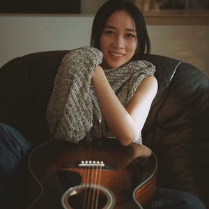 Portrait of smiling young woman sitting on sofa