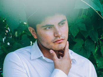 Close-up of man against plants at park