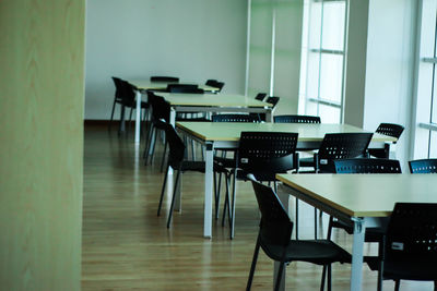 Empty chairs and tables in room