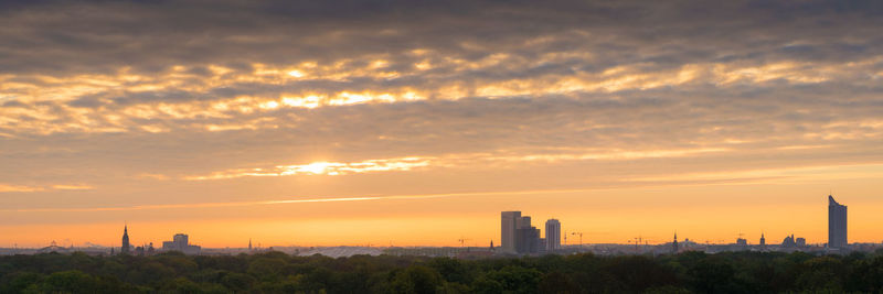 Scenic view of buildings against sky during sunset