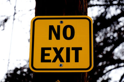 Low angle view of road sign against sky