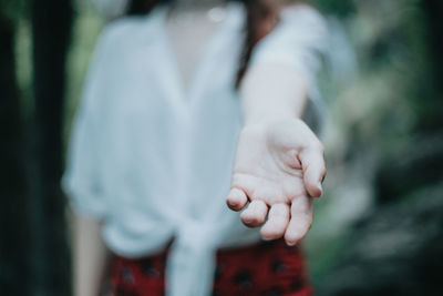 Midsection of woman holding hands