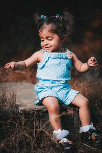 Cute girl sitting on land