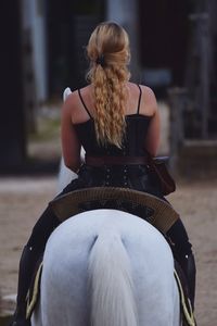 Rear view of woman riding horse