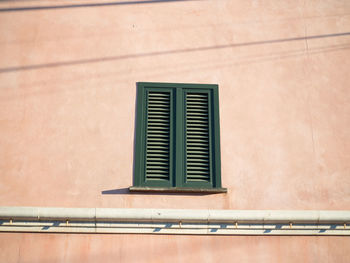 Low angle view of window on wall of building