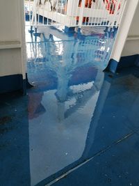 Reflection of building in puddle on glass window