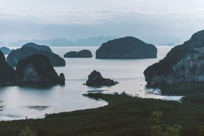 Rocks in sea against sky