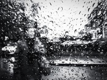 Full frame shot of wet glass window in rainy season