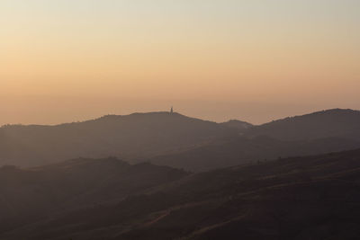 Scenic view of silhouette mountains against sky during sunset