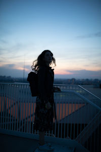 Silhouette backpack woman standing on steps