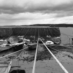 Boats moored on sea against sky