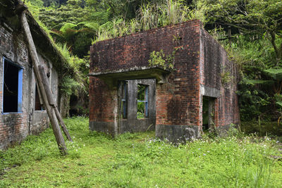 Old abandoned building on field