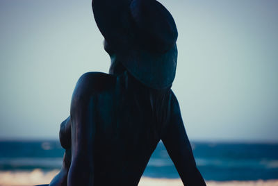 Man standing on beach against clear sky