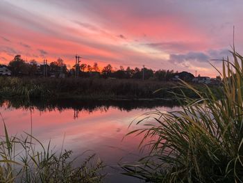 Scenic view of lake against romantic sky at sunset