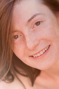 Close-up portrait of a smiling young woman