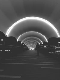 Rear view of people walking in illuminated city