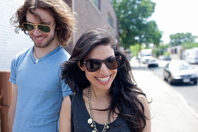 Couple wearing sunglasses walking down the street