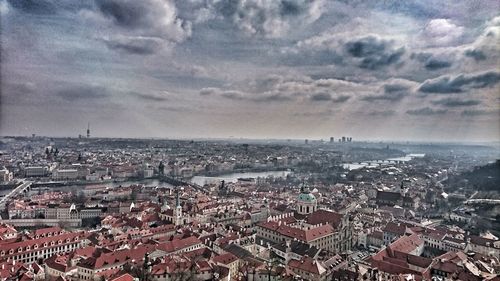 High angle view of townscape by sea against sky