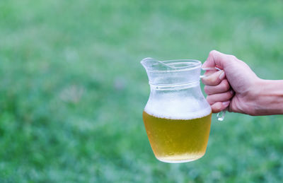 Hand holding glass of drink