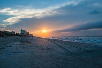 Scenic view of beach against sky during sunset