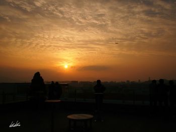 Silhouette of city during sunset