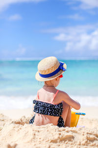 Full length of child on beach against sky