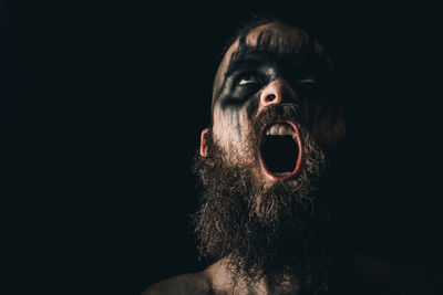 Portrait of man against black background