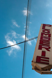 Low angle view of cables against blue sky