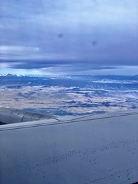 Airplane flying over clouds in sky