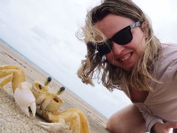 Portrait of young woman with sunglasses on beach