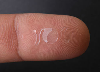 Close-up of human hand against black background