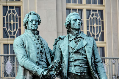 Statue against historic building