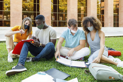 Male and female students studying together in campus at university