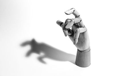 Close-up of hands against white background