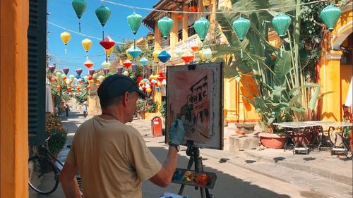 Rear view of man standing in market